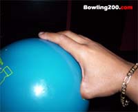 Thumb inserted into bowling ball